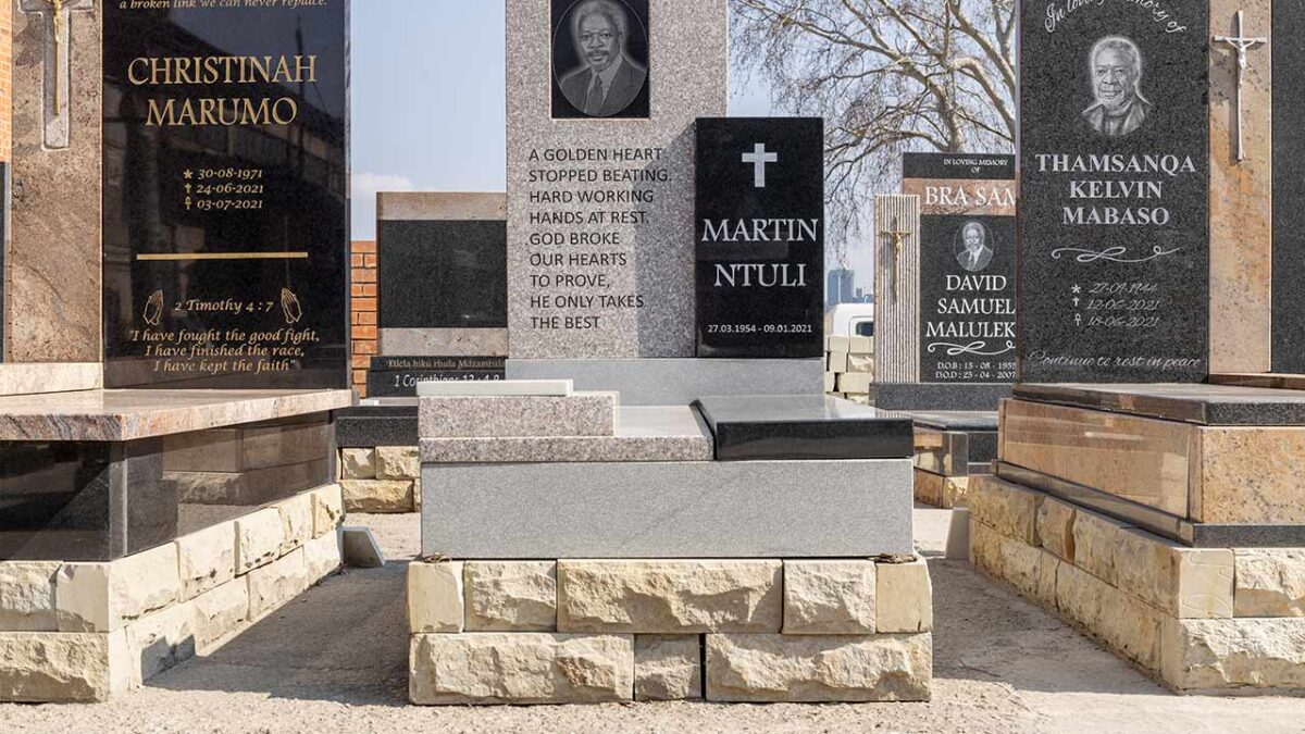 Customer viewing granite tombstone designs with consultant at Tombstone Factory showroom