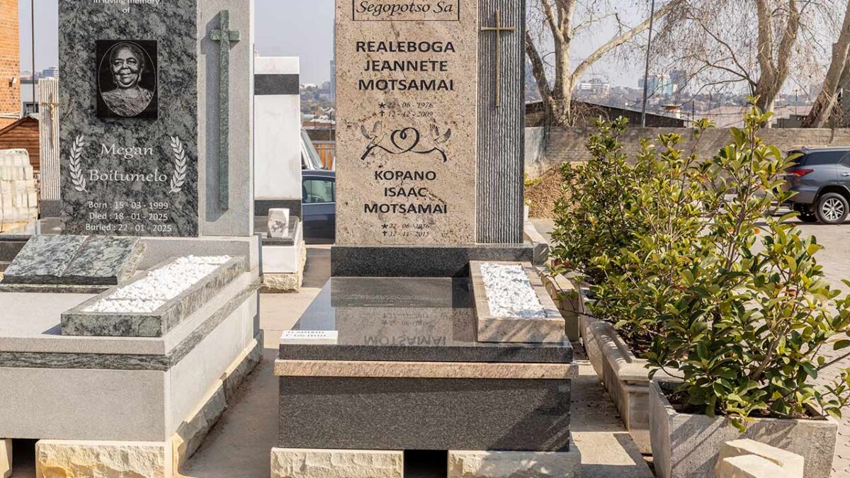Close-up of granite tombstone with matching vase and engraved plaque