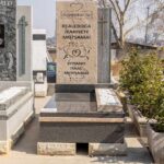Close-up of granite tombstone with matching vase and engraved plaque