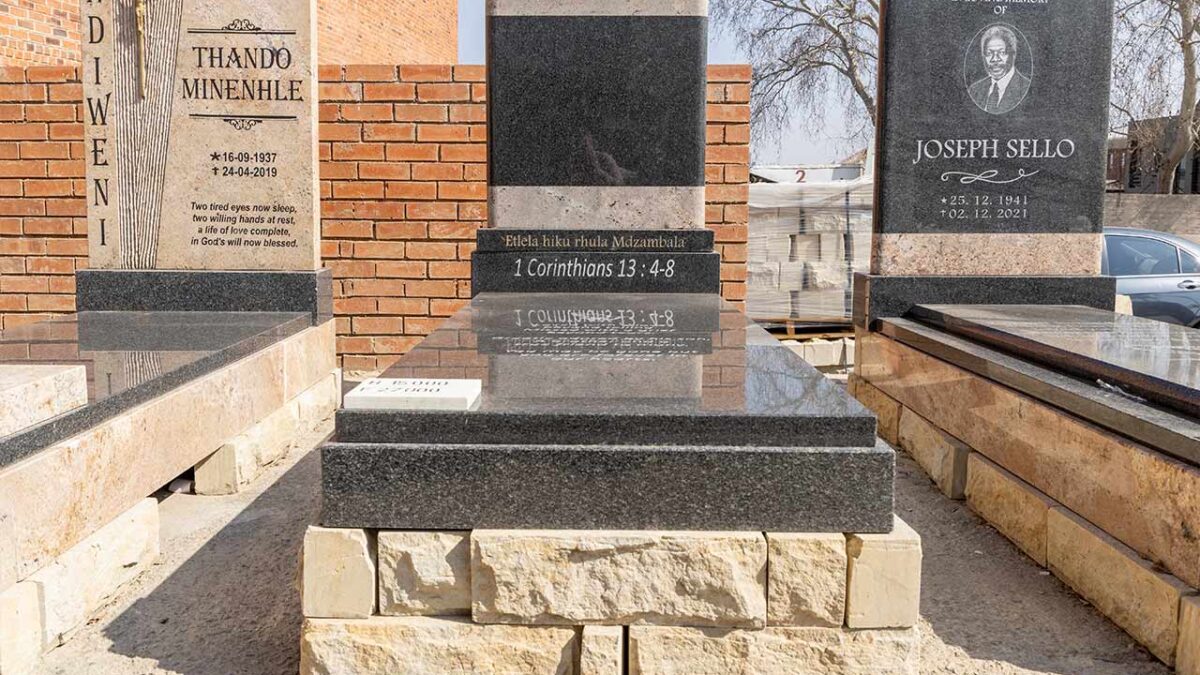 Family placing flowers at a granite tombstone during a peaceful memorial visit