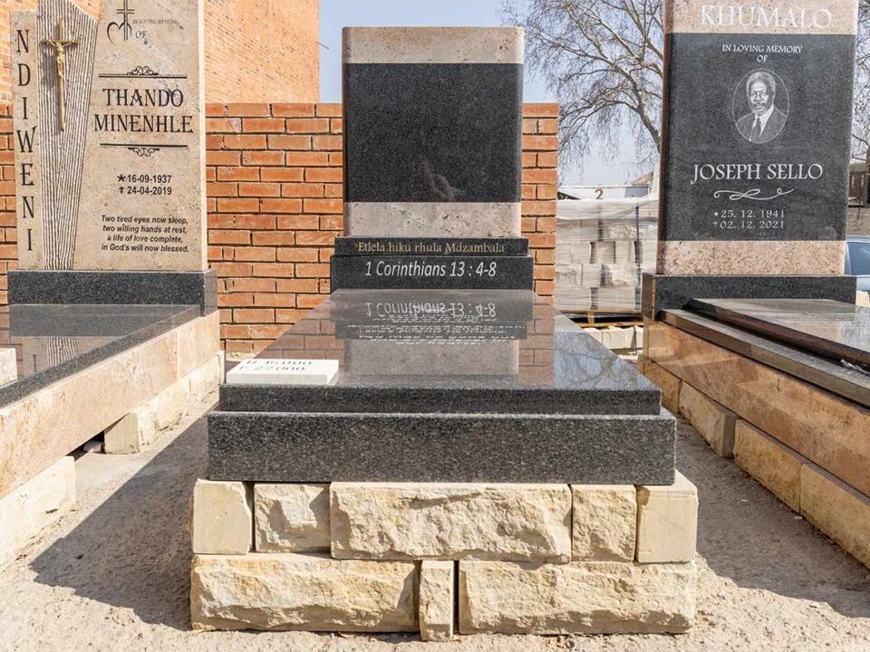 Family placing flowers at a granite tombstone during a peaceful memorial visit