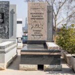 Restoration expert re-lettering an old granite tombstone in Johannesburg